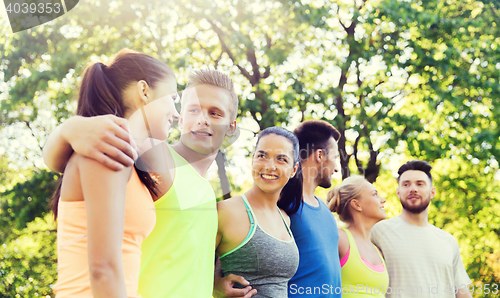 Image of group of happy friends or sportsmen outdoors