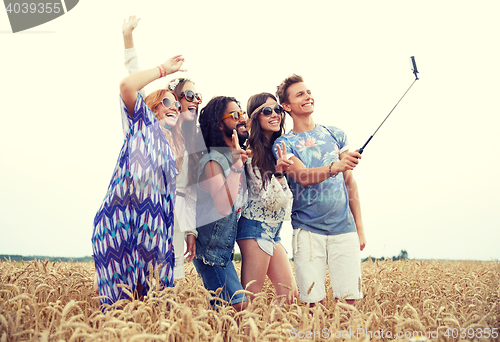 Image of hippie friends with smartphone on selfie stick