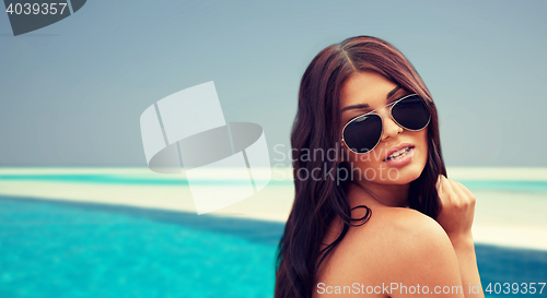 Image of young woman with sunglasses on beach