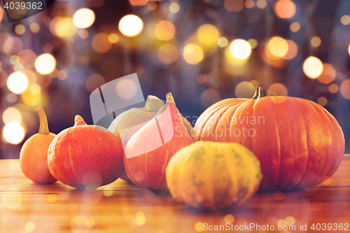 Image of close up of halloween pumpkins on wooden table