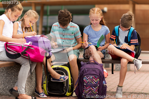 Image of group of happy elementary school students outdoors