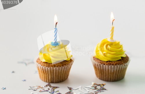 Image of birthday cupcakes with burning candles