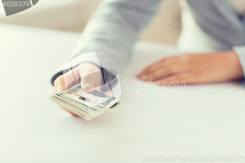 Image of close up of woman hands holding us dollar money