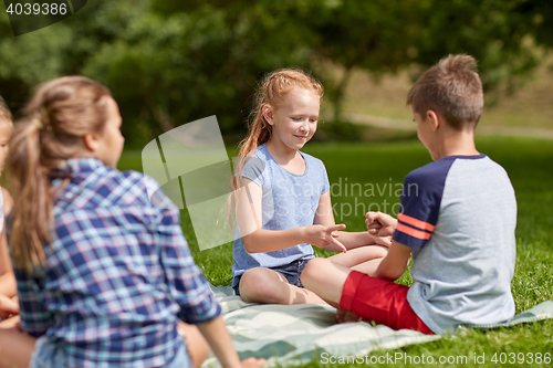 Image of happy kids playing rock-paper-scissors game