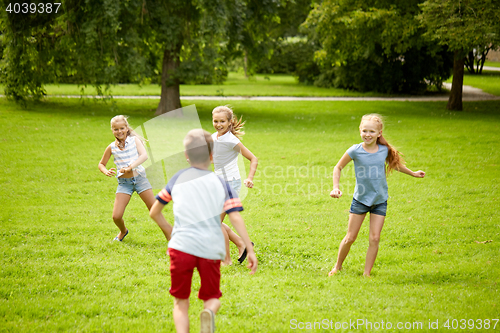 Image of happy kids running and playing game outdoors