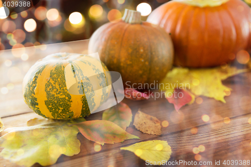 Image of close up of halloween pumpkins on wooden table