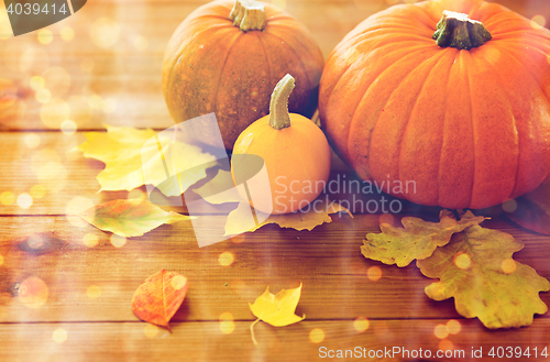 Image of close up of pumpkins on wooden table at home