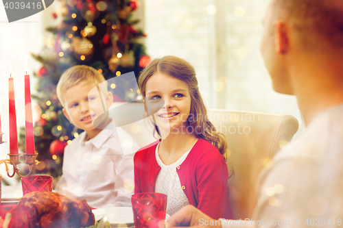 Image of smiling family having holiday dinner at home