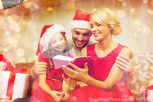 Image of smiling family reading book