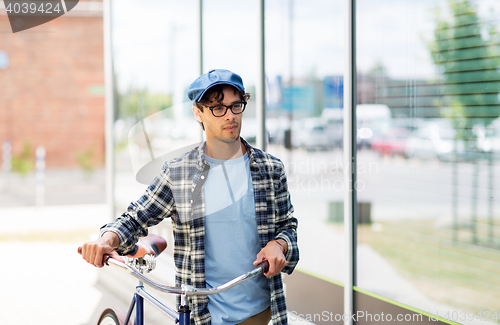 Image of hipster man walking with fixed gear bike