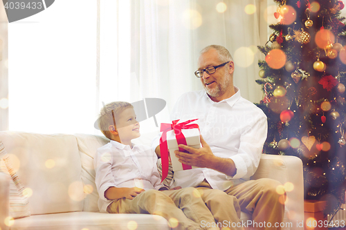 Image of smiling grandfather and grandson at home