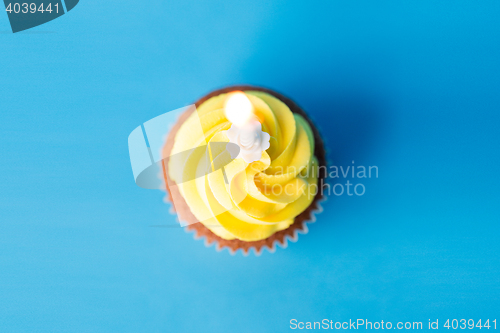Image of birthday cupcake with one burning candle
