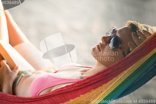 Image of relaxed woman laying in hammock
