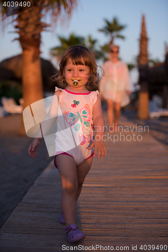 Image of girl and mother walking