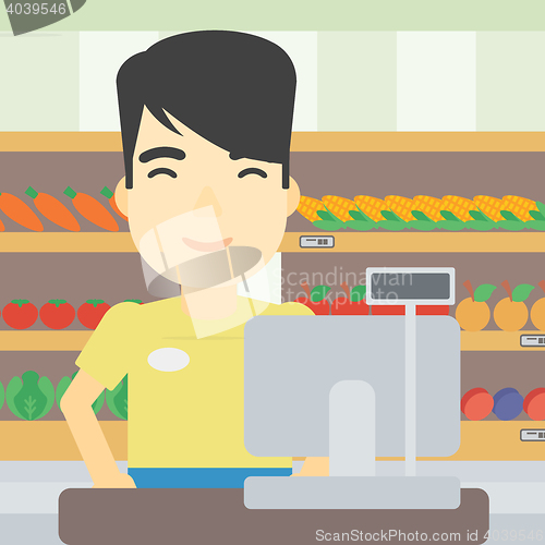 Image of Cashier standing at the checkout in supermarket.