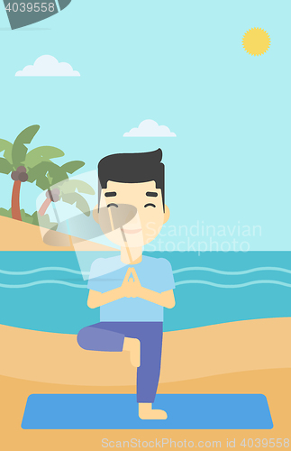 Image of Man practicing yoga tree pose on the beach.
