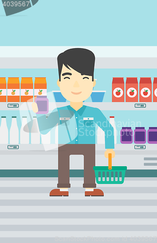 Image of Customer with shopping basket and tube of cream.