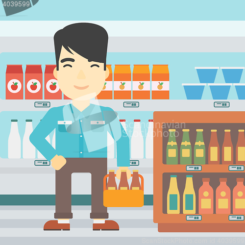 Image of Man with pack of beer at supermarket.