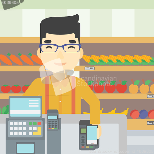 Image of Customer paying wireless with smartphone.