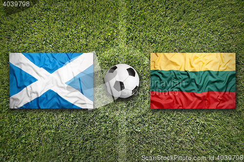 Image of Scotland and Lithuania flags on soccer field