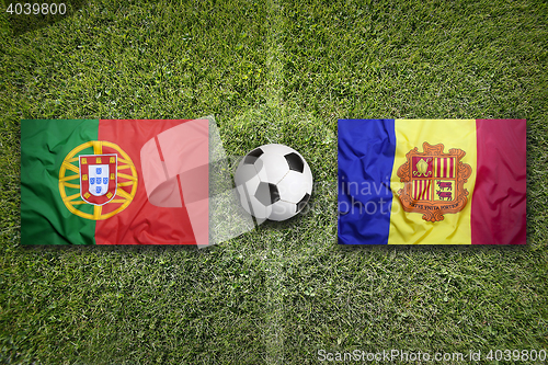 Image of Portugal and Andorra flags on soccer field