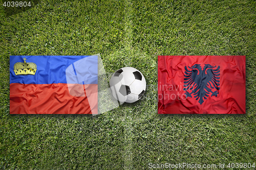 Image of Liechtenstein and Albania flags on soccer field