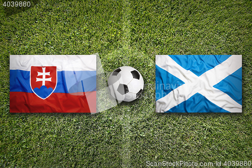 Image of Slovakia vs. Scotland flags on soccer field