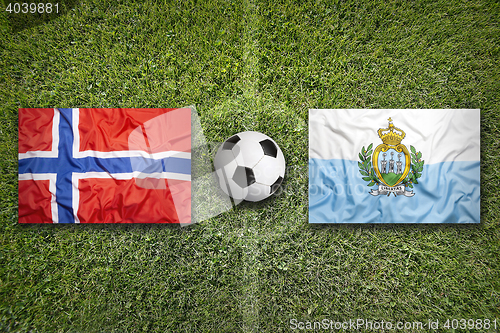Image of Norway vs. San Marino flags on soccer field