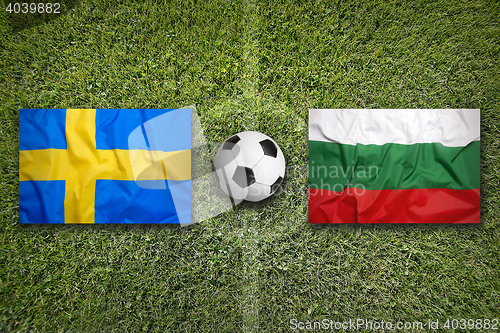 Image of Sweden vs. Bulgaria flags on soccer field