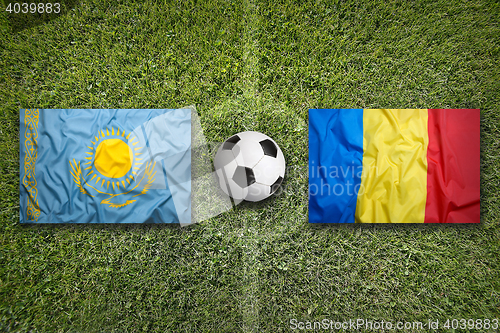 Image of Kazakhstan vs. Romania flags on soccer field