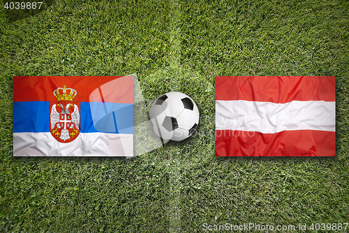 Image of Serbia vs. Austria flags on soccer field