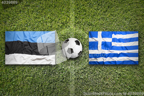 Image of Estonia vs. Greece flags on soccer field