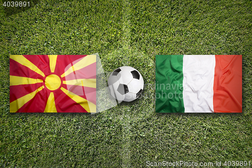Image of Macedonia vs. Italy flags on soccer field