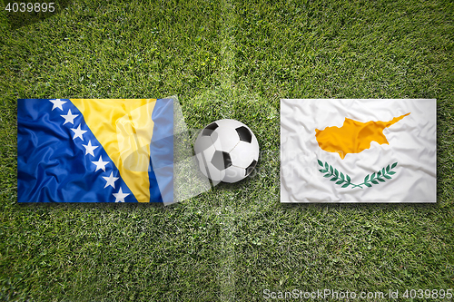 Image of Bosnia and Herzegovina vs. Cyprus flags on soccer field