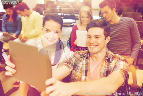 Image of group of smiling students with tablet pc