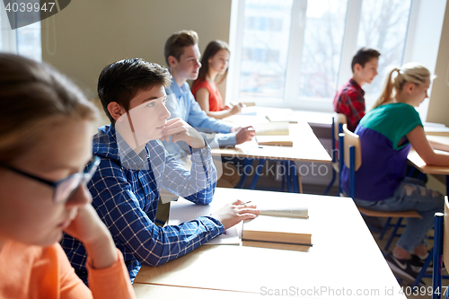 Image of group of students with books at school lesson