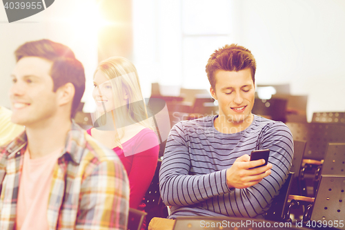 Image of group of smiling students in lecture hall