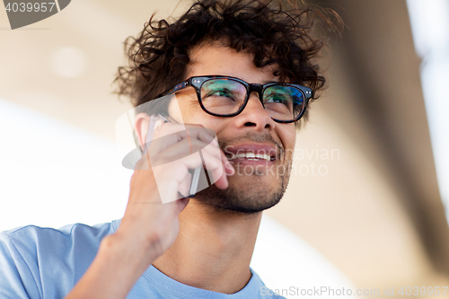 Image of man with smartphone calling on city street