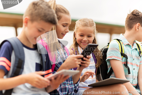 Image of group of happy elementary school students talking