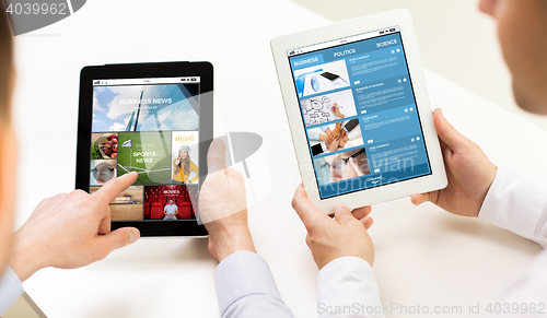 Image of close up of businessman hands with tablet pc