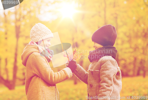 Image of smiling children in autumn park