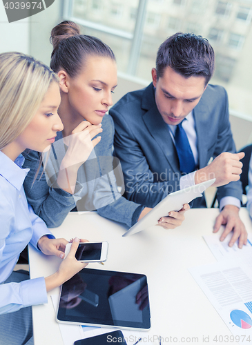 Image of business team with tablet pc having discussion