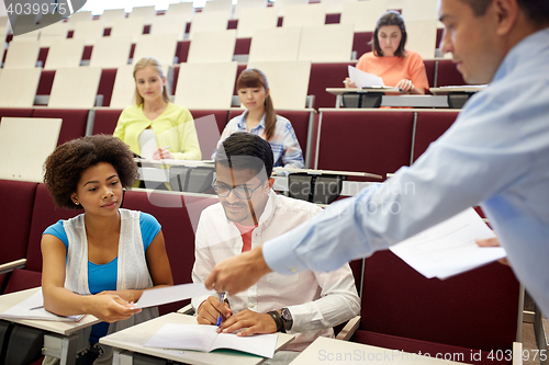 Image of teacher giving tests to students at lecture