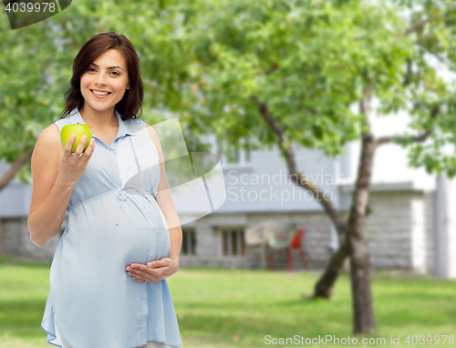 Image of happy pregnant woman holding green apple