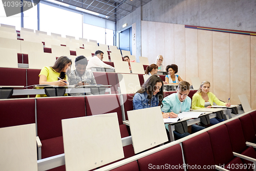 Image of group of students with notebooks at lecture hall