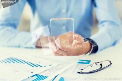 Image of close up of woman with transparent smartphone