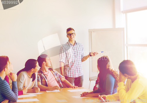 Image of group of smiling students with flip board