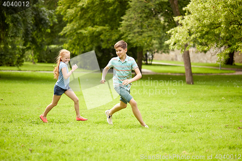 Image of happy kids running and playing game outdoors