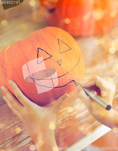 Image of close up of woman with pumpkins at home
