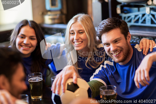 Image of football fans or friends with beer at sport bar